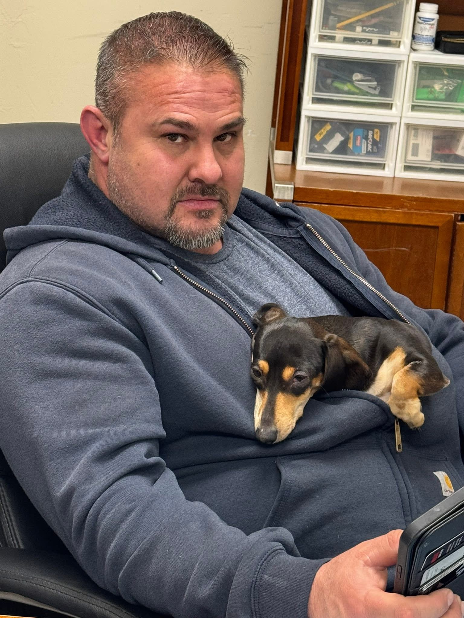 Joseph Gonzalez, co-owner and veteran, with his dachshund Mags
